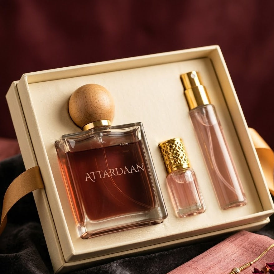 Naya Rishta gift set for your bhabhi — an Attardaan eau de parfum, attar vial and body mist in a cream box on dark velvet, with a rakhi and rose petals